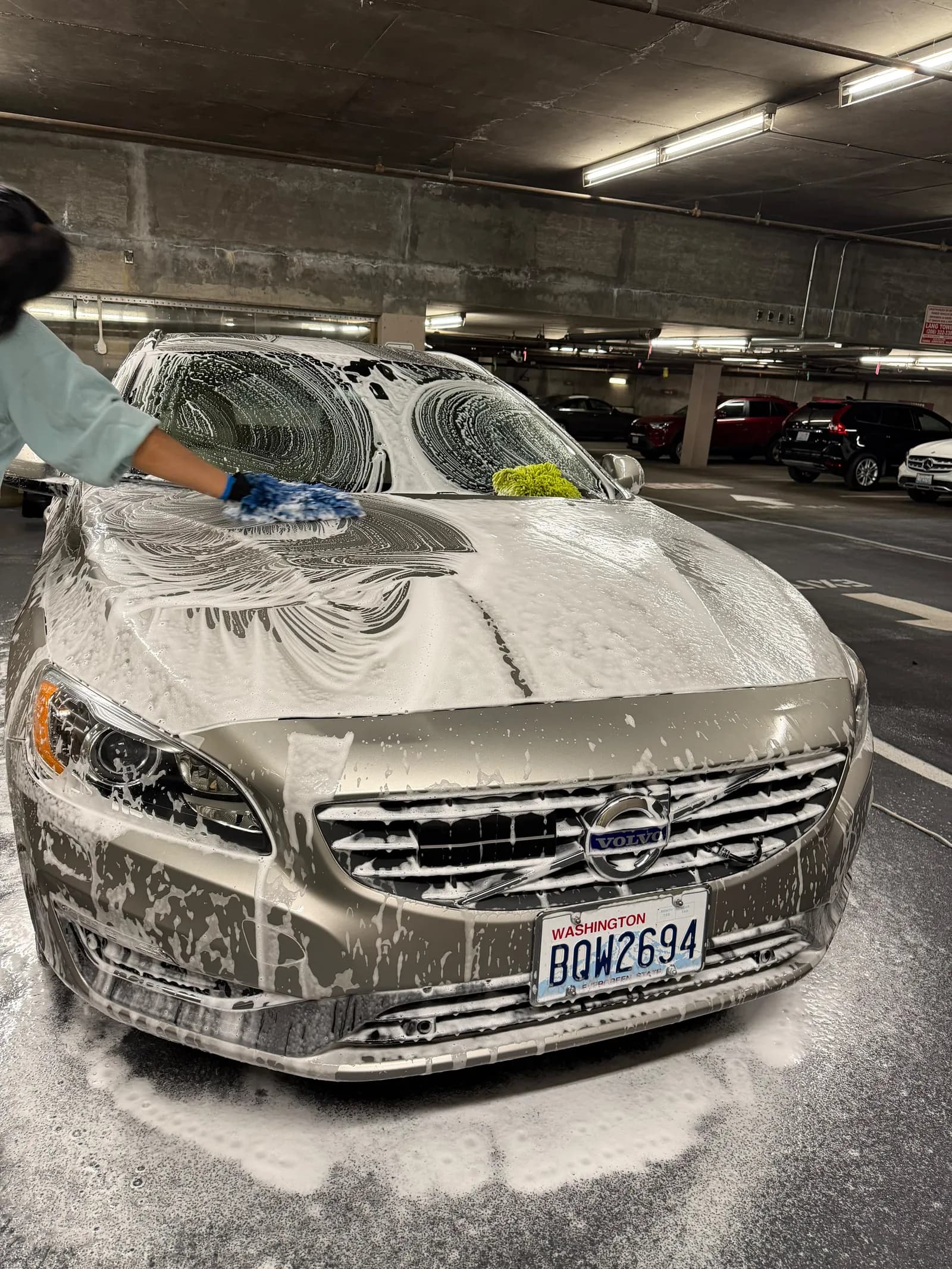 Two-bucket hand wash being performed on a customer's car